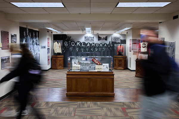 Students walk past the Oklahoma Pride exhibit in Bizzell